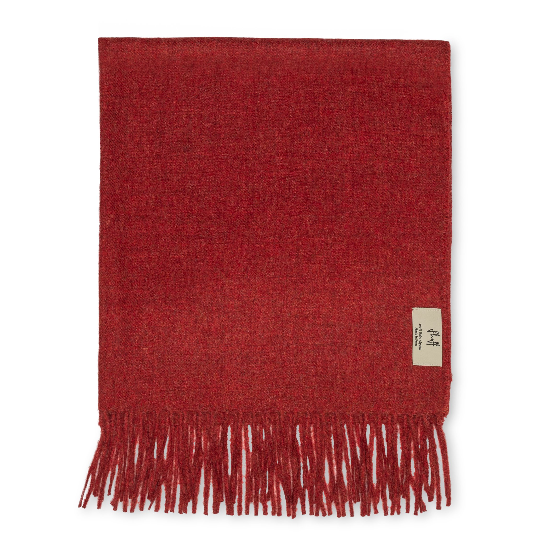 Red throw with fringes on a white background