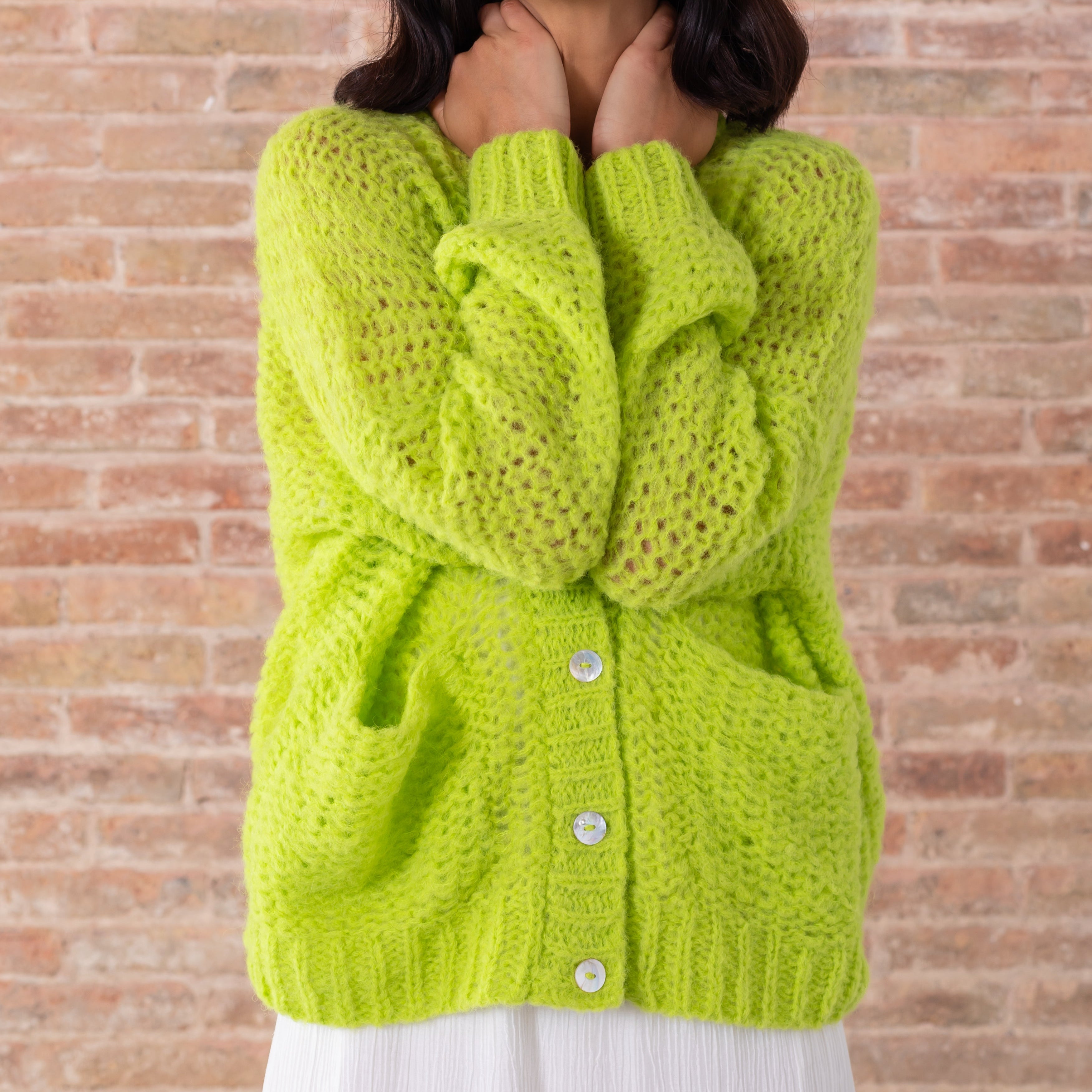 Light green baby alpaca cardigan v neck white buttons modeled front close up modeled