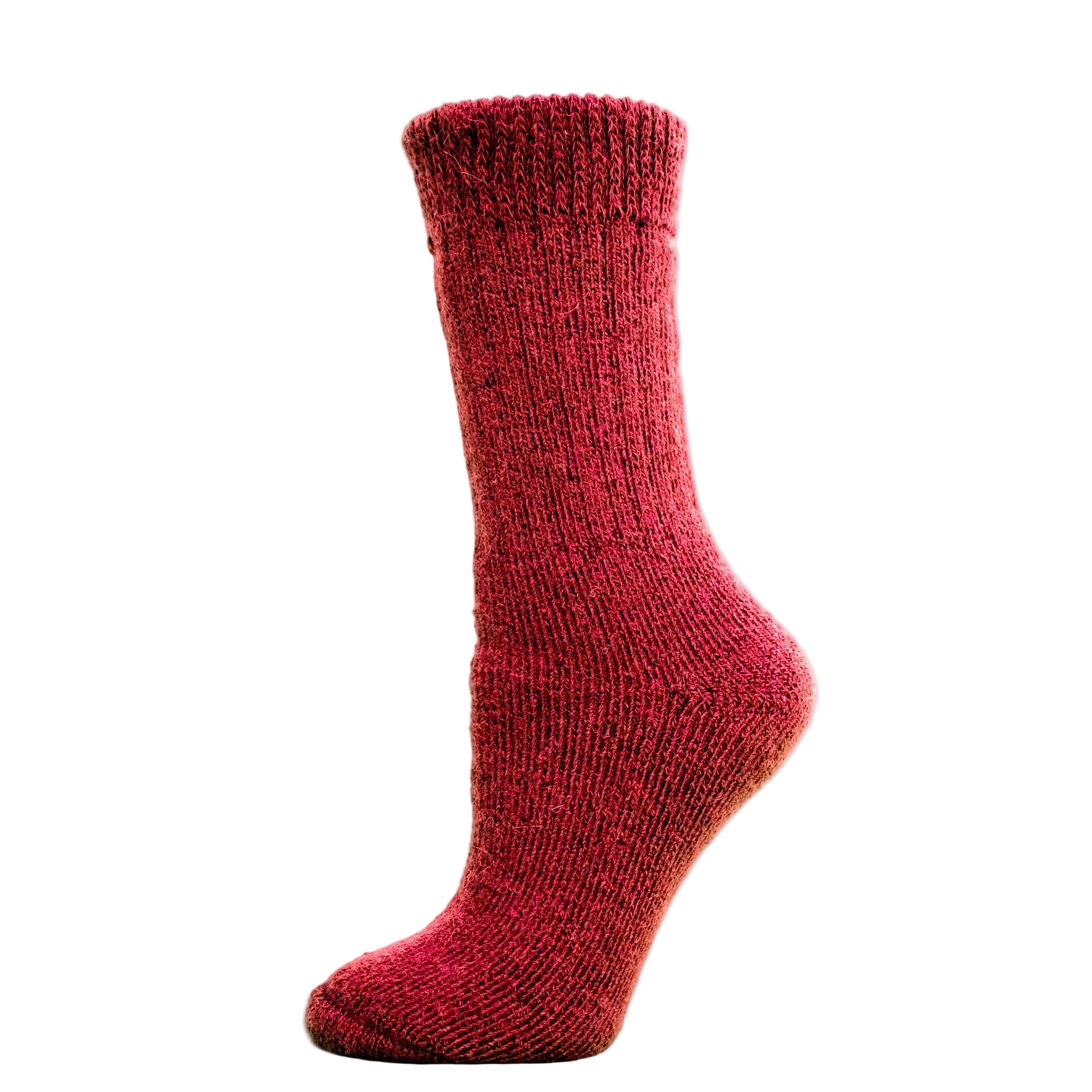 Andinista Alpaca Hiking Socks, a picture of a foot wearing a pair of red alpaca hiking socks on a wooden crate.
