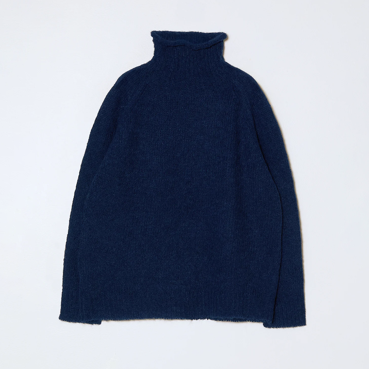 Navy blue knit turtleneck sweater on a neutral background.