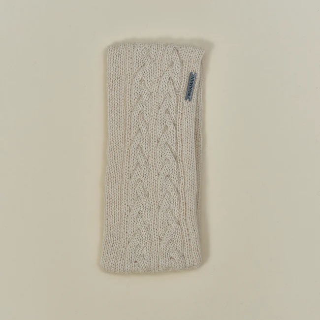 White knitted headband with a brand logo on a beige background