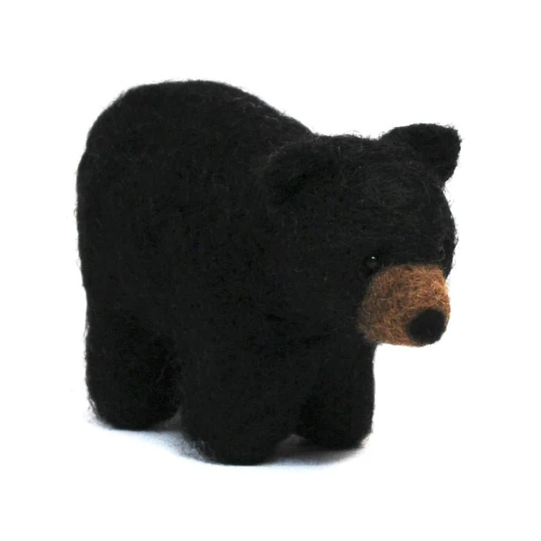 Black bear felted toy on a white background