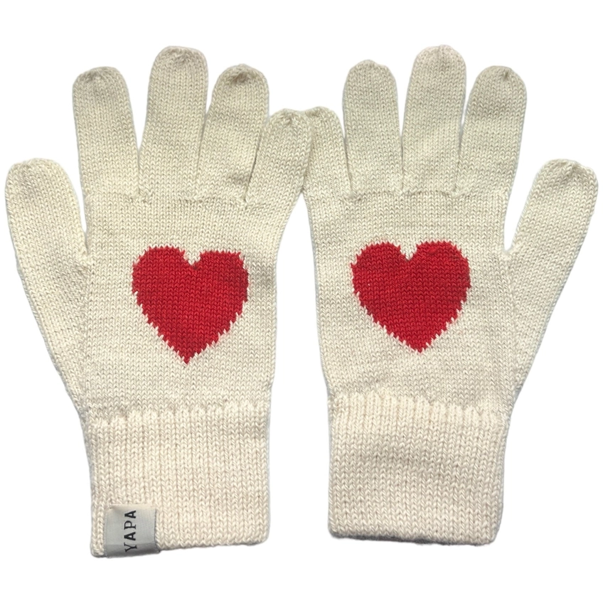Pair of cream gloves with red heart designs on a white background
