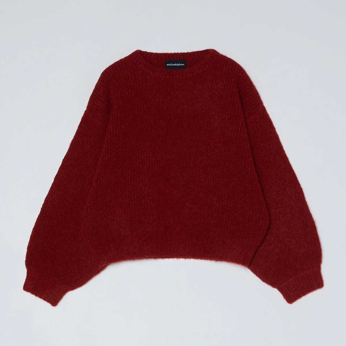 Red knit sweater on a white background