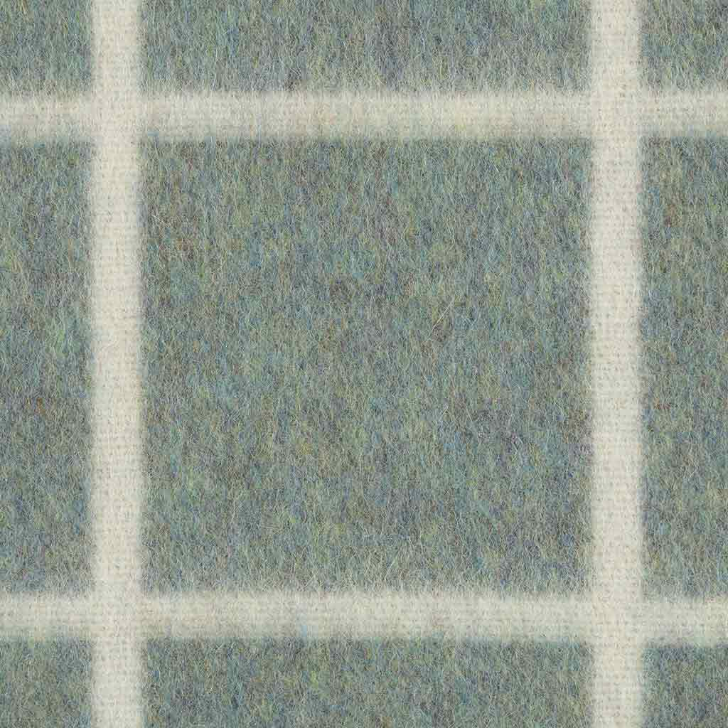 Textured blanket with a grid pattern in shades of green and white
