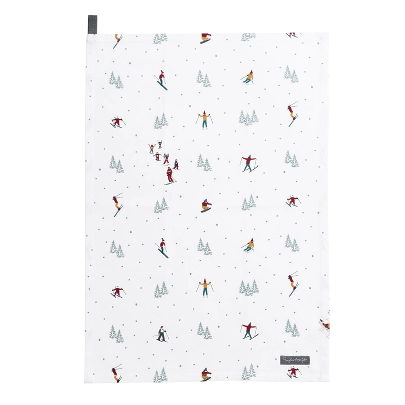 Patterned tea towel with skiers and trees on a white background