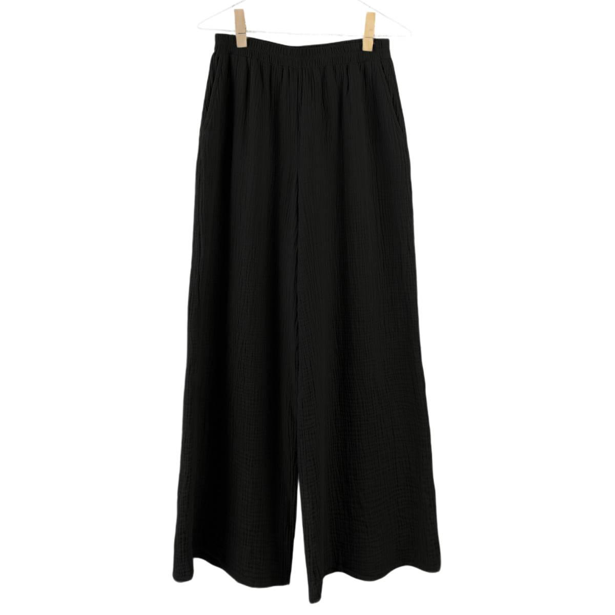 Black wide-leg pants hanging on a white background