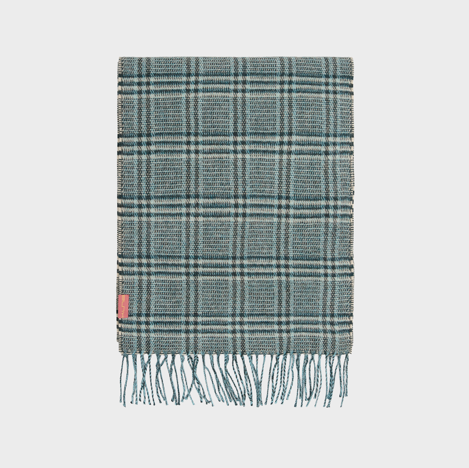 Green plaid scarf with fringes on a light gray background