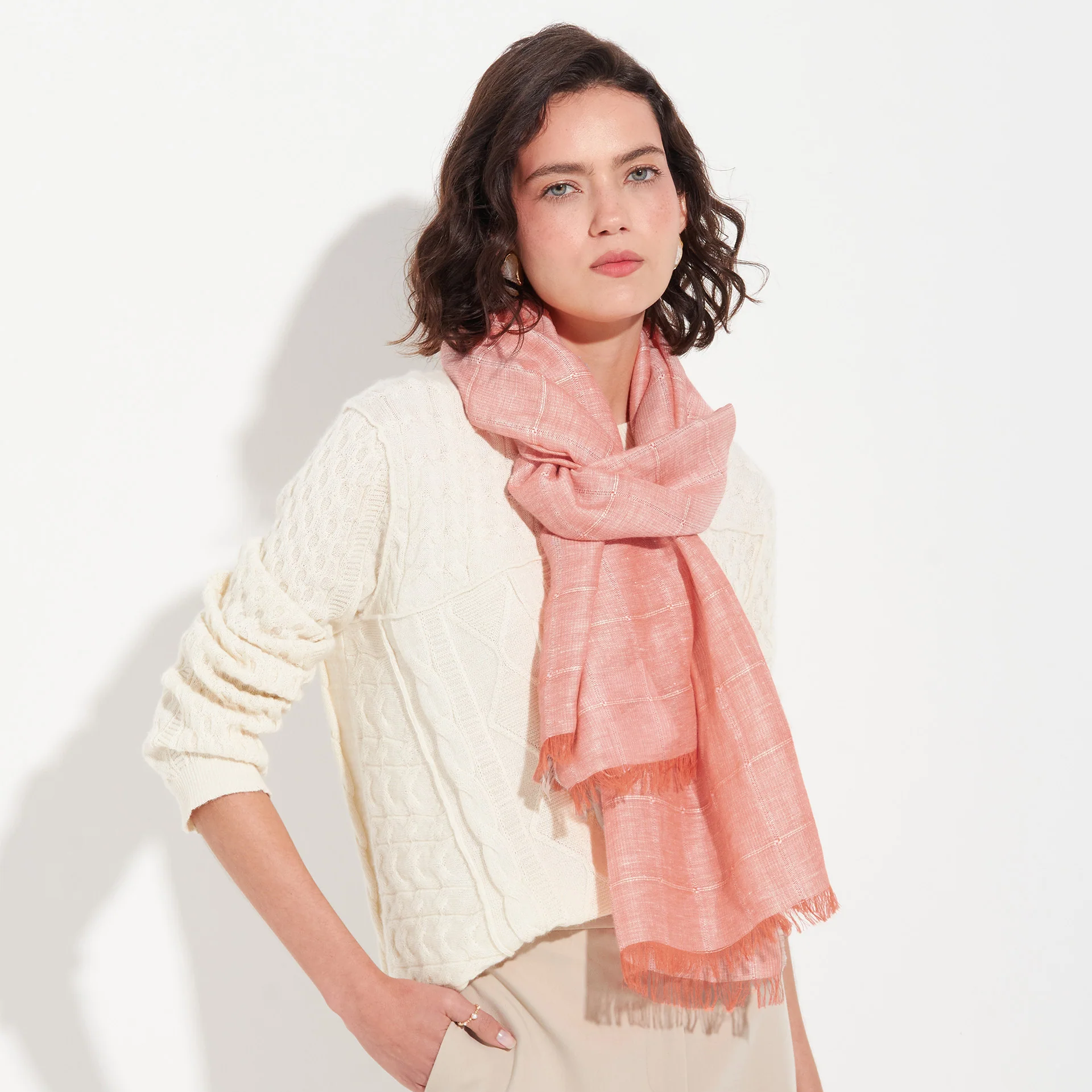 Woman wearing an orange scarf on a white background