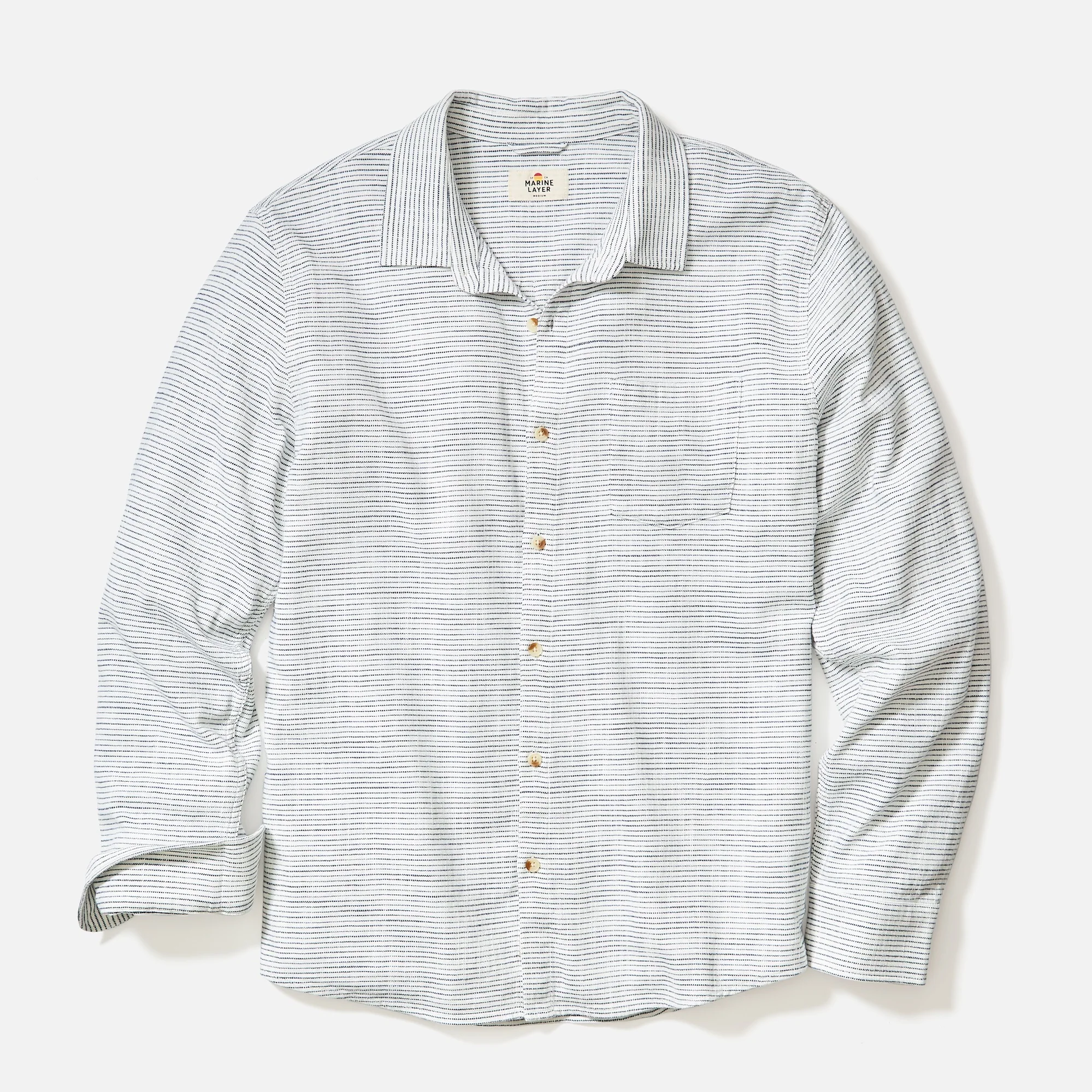 Striped shirt with button details on a light gray background