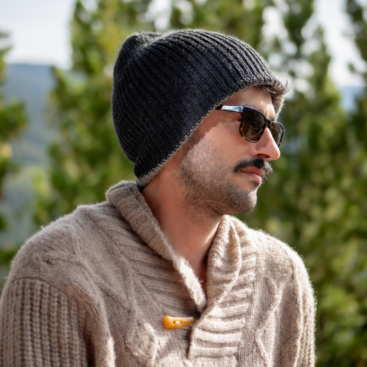Man wearing the reversible baby alpaca beanie with the charcoal side facing out