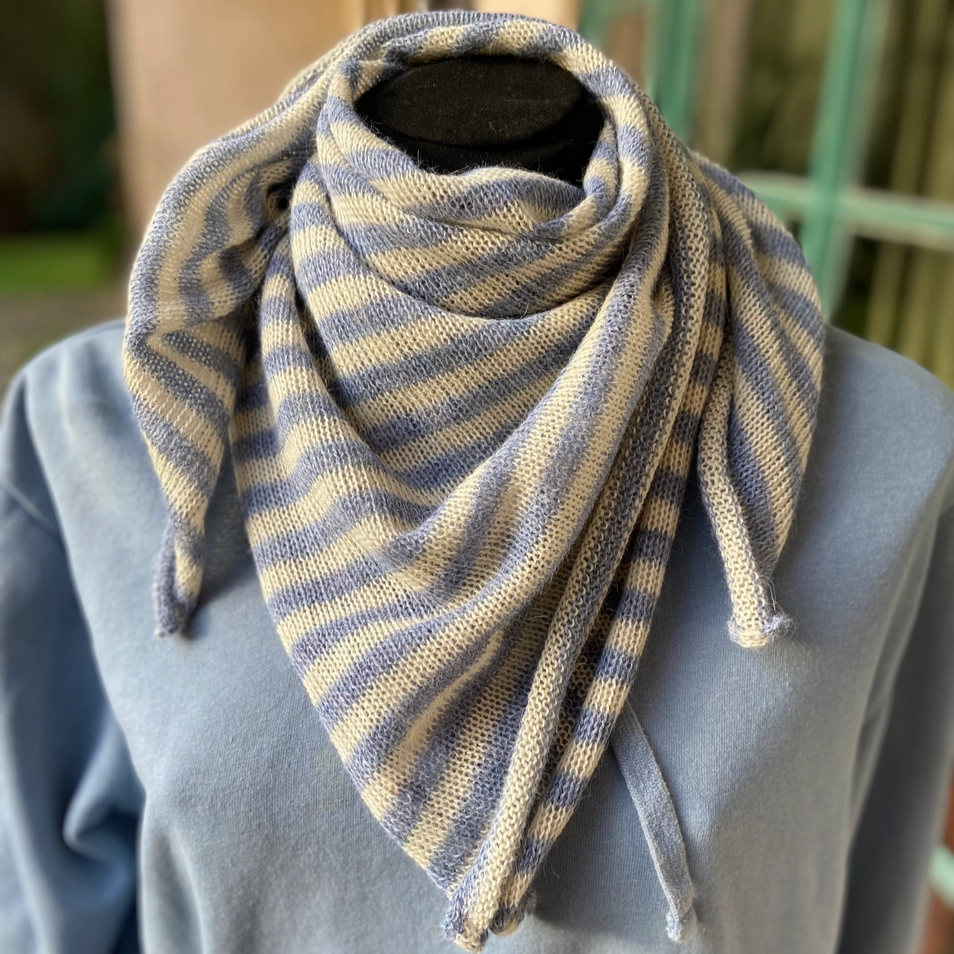 Light blue and white striped scarf wrapped around mannequin