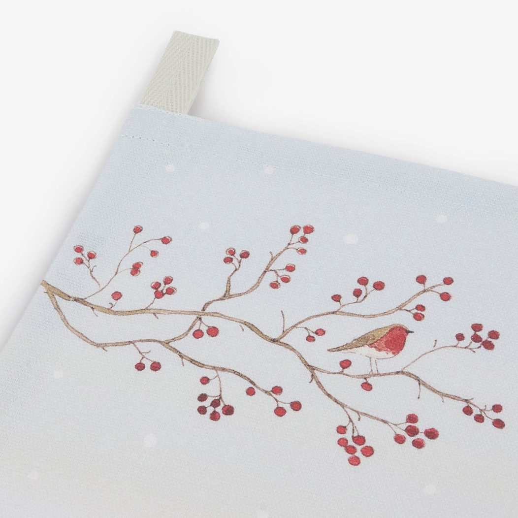 Tea towel with a design of a robin on a branch with berries on a white background