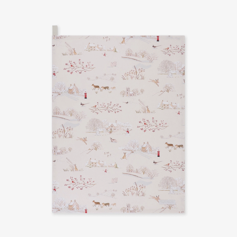 A tea towel featuring a delicate winter landscape print on a warm cream background. The pattern includes muted brown trees, small red birds, and tiny figures of people and animals.