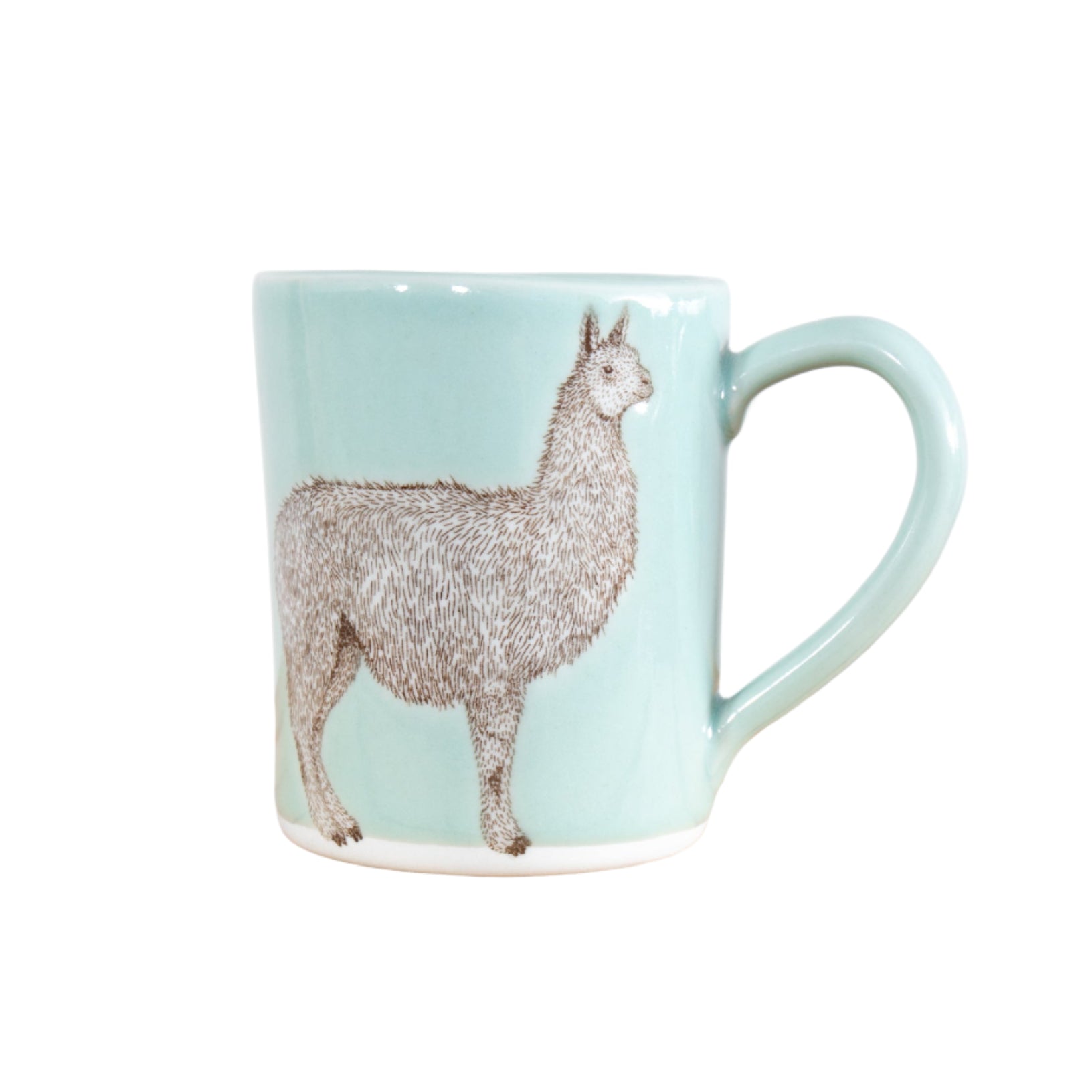 A light blue ceramic mug with a celadon glaze and a beige illustration of a llama on the side, placed on a wooden surface.