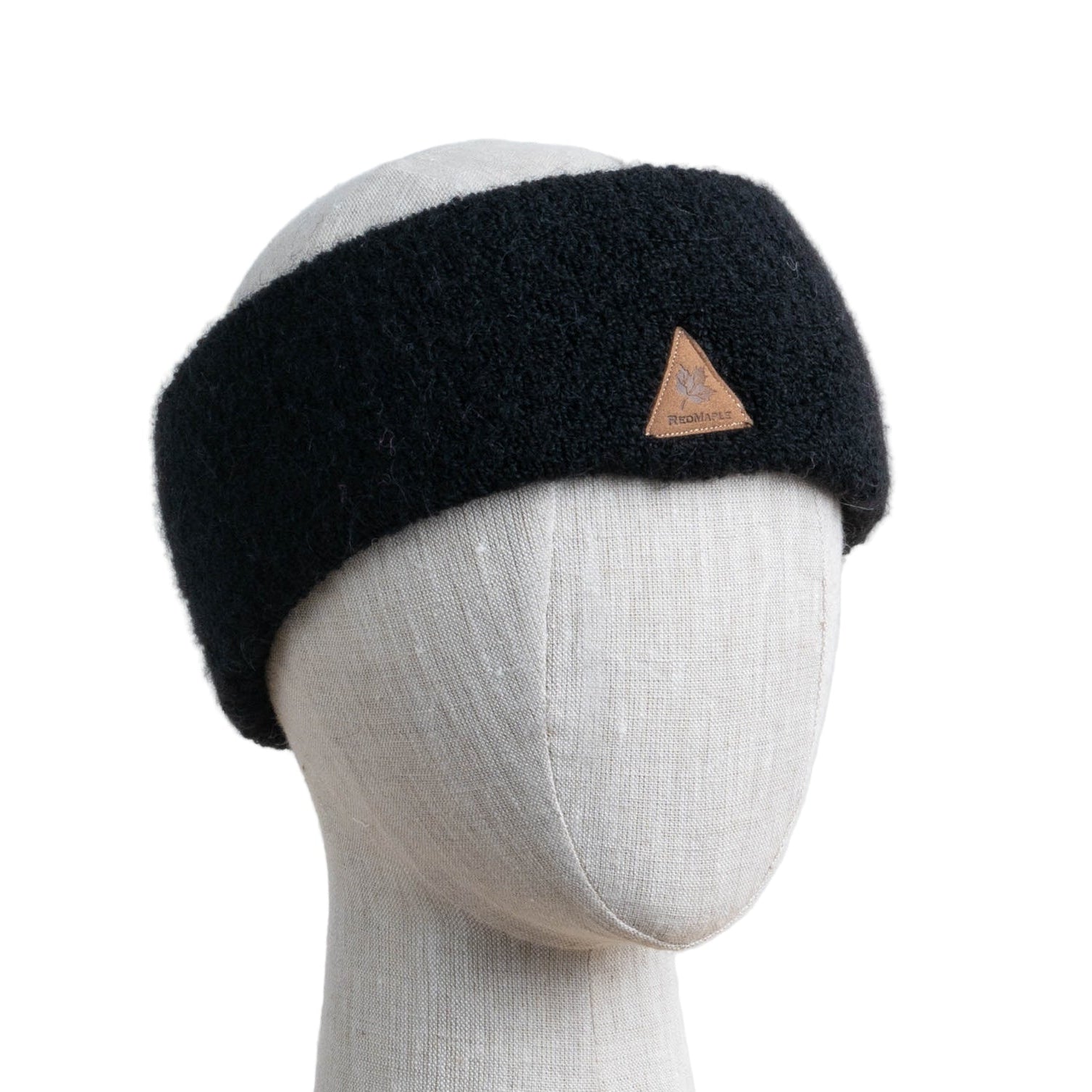 A black alpaca ski headband on a mannequin head.