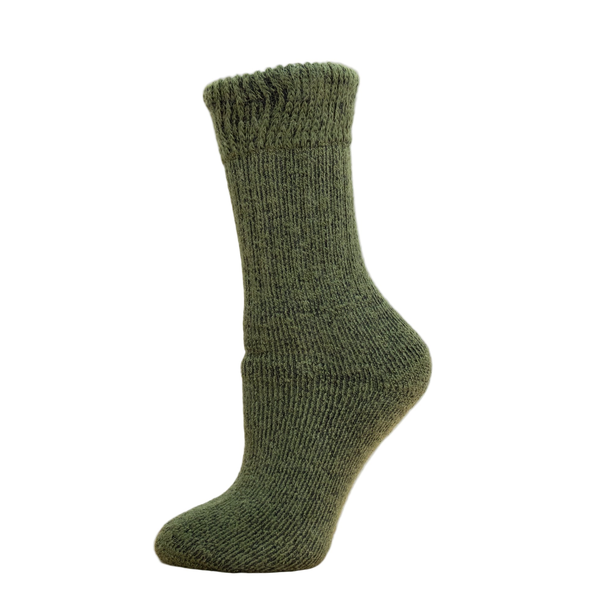 Andinista Alpaca Hiking Socks, a picture of a foot wearing a pair of green alpaca hiking socks on a wooden crate.