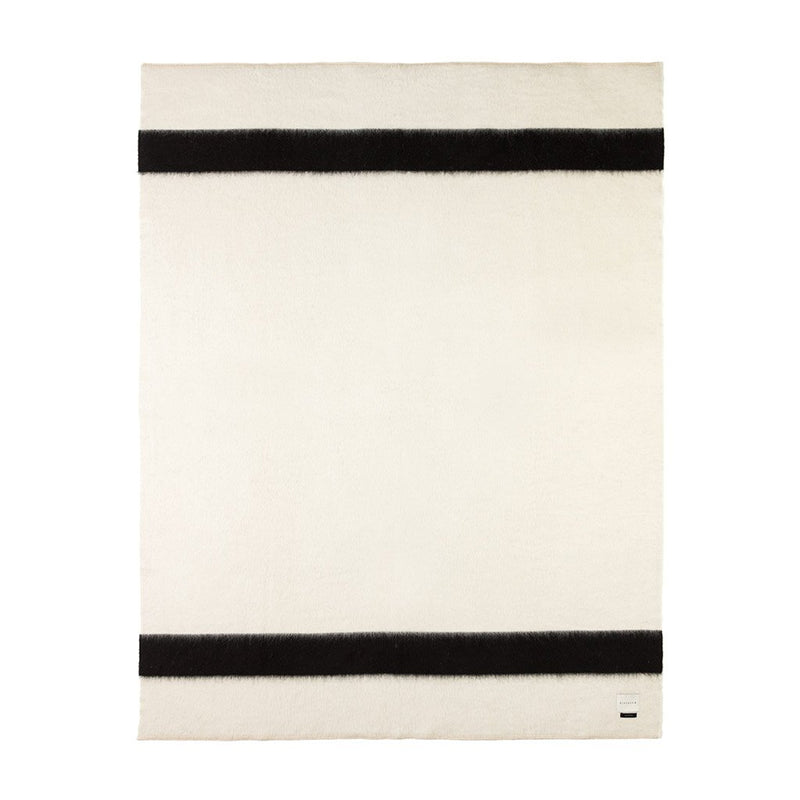 A rolled hem blanket with antique white blanket stitching and black horizontal stripes.