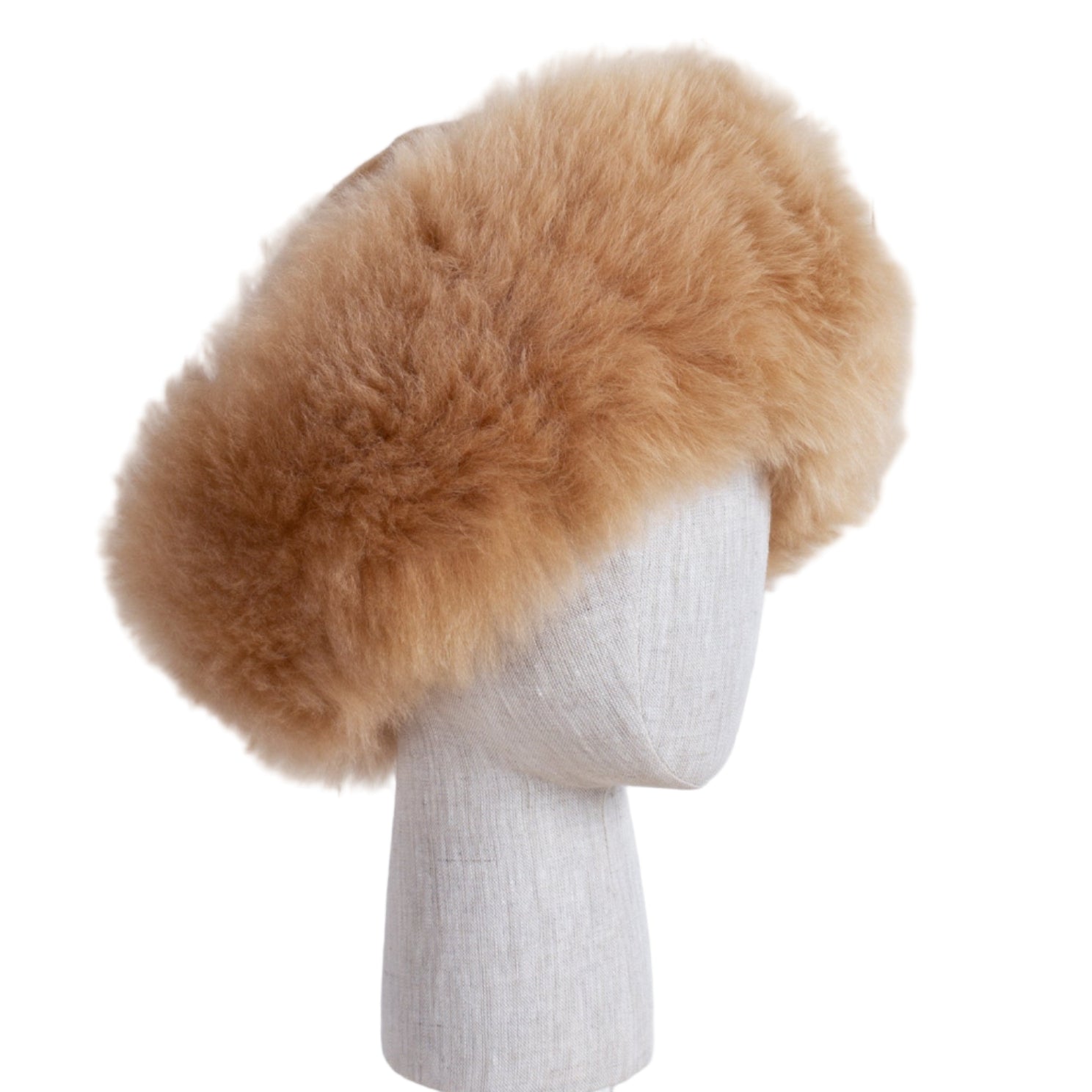 Premium Baby Alpaca Fur Hat. A light brown/fawn Premium Baby Alpaca Fur Hat on a mannequin head against a white paneled background.