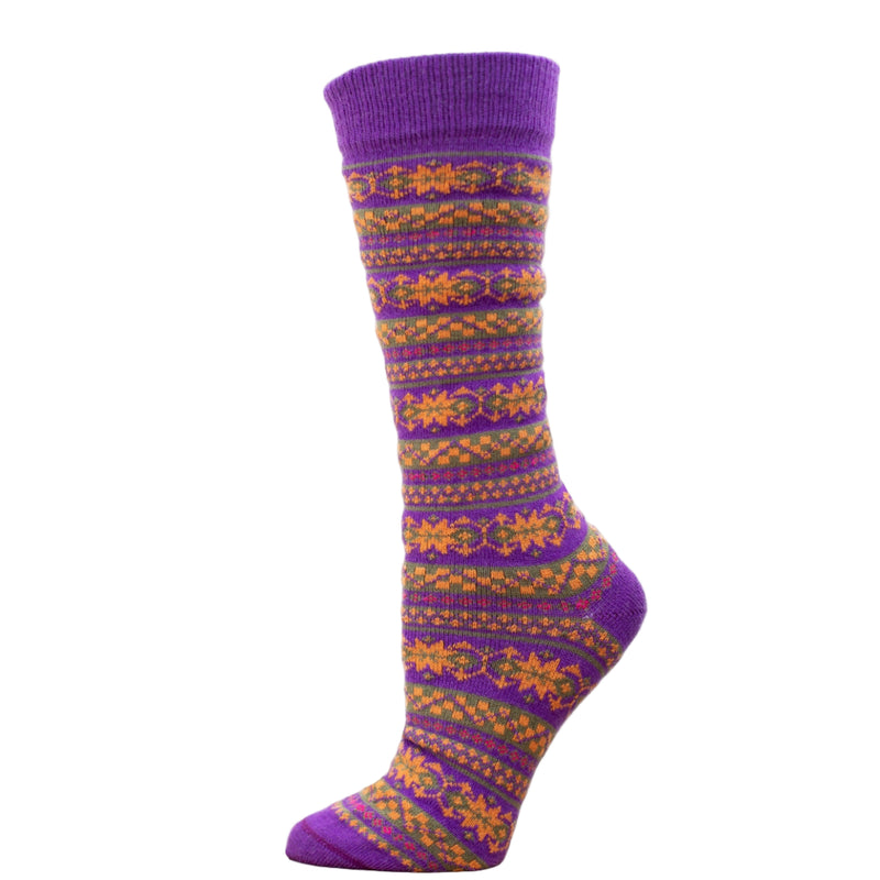 A purple alpaca wool sock with Fair Isle patterns in orange and yellow, displayed on a wooden platform.