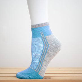 Alpaca Running  and Athletic Ankle Socks. A pair of light blue alpaca ankle running socks in front of a white background. 