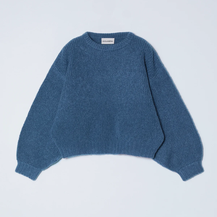Blue sweater on a light gray background
