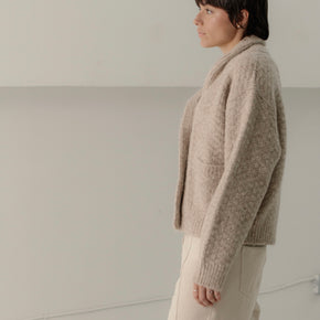 Bare Knitwear Bowen Shawl Cardigan - person wearing wheat colored button down cardigan on a neutral background