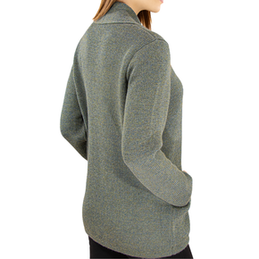 Green knitted sweater worn by a person on a white background