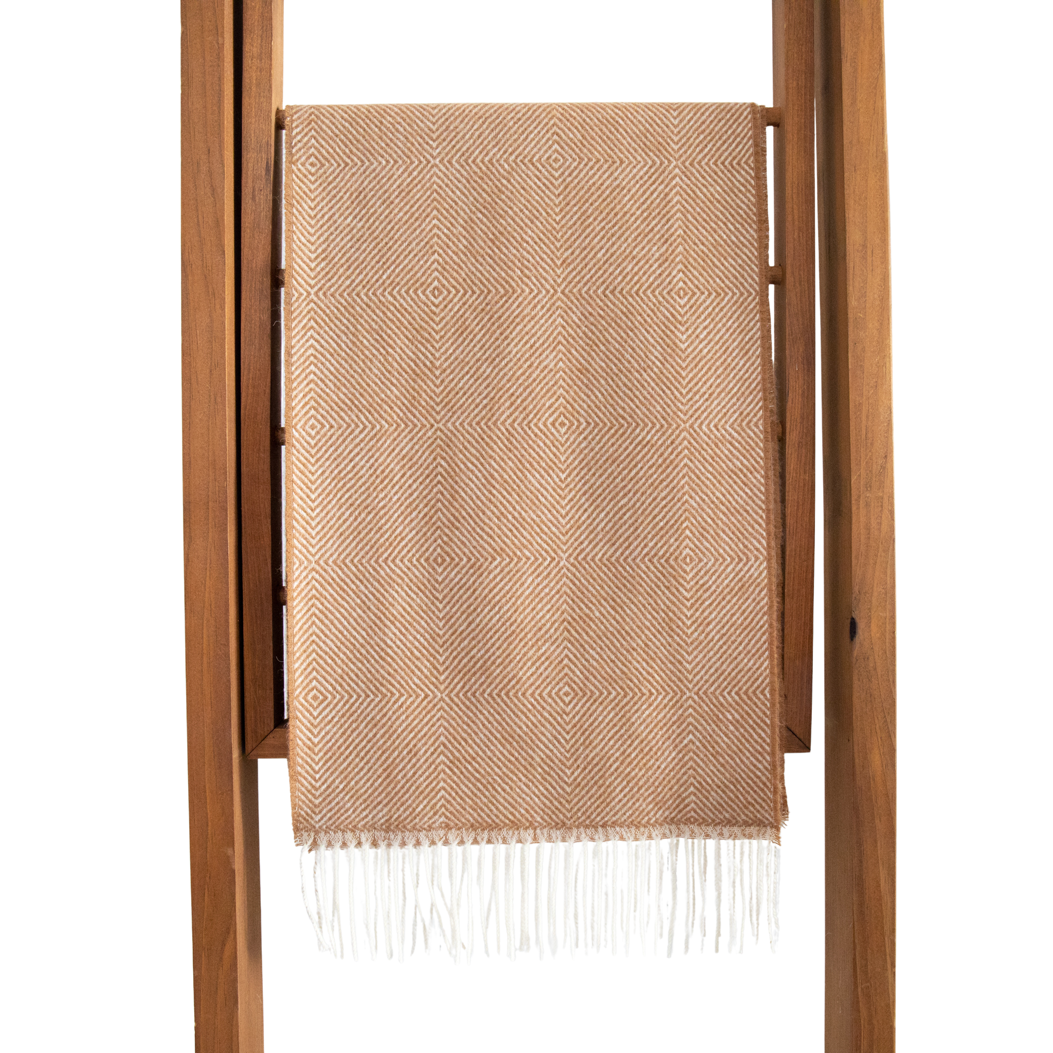 Beige woven scarf with white fringe draped over a wooden ladder on a white background