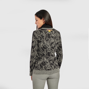 Kuna Weiss Sweater - model wearing black and white reversible floral sweater on a neutral background