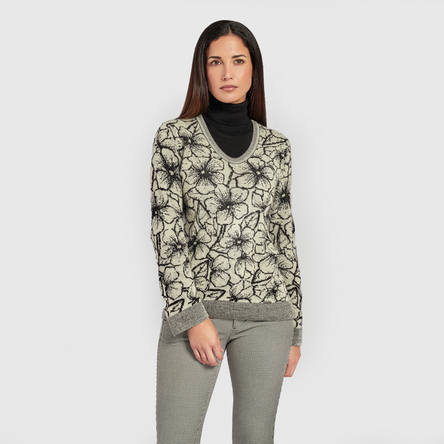 Kuna Weiss Sweater - model wearing black and white reversible floral sweater on a neutral background