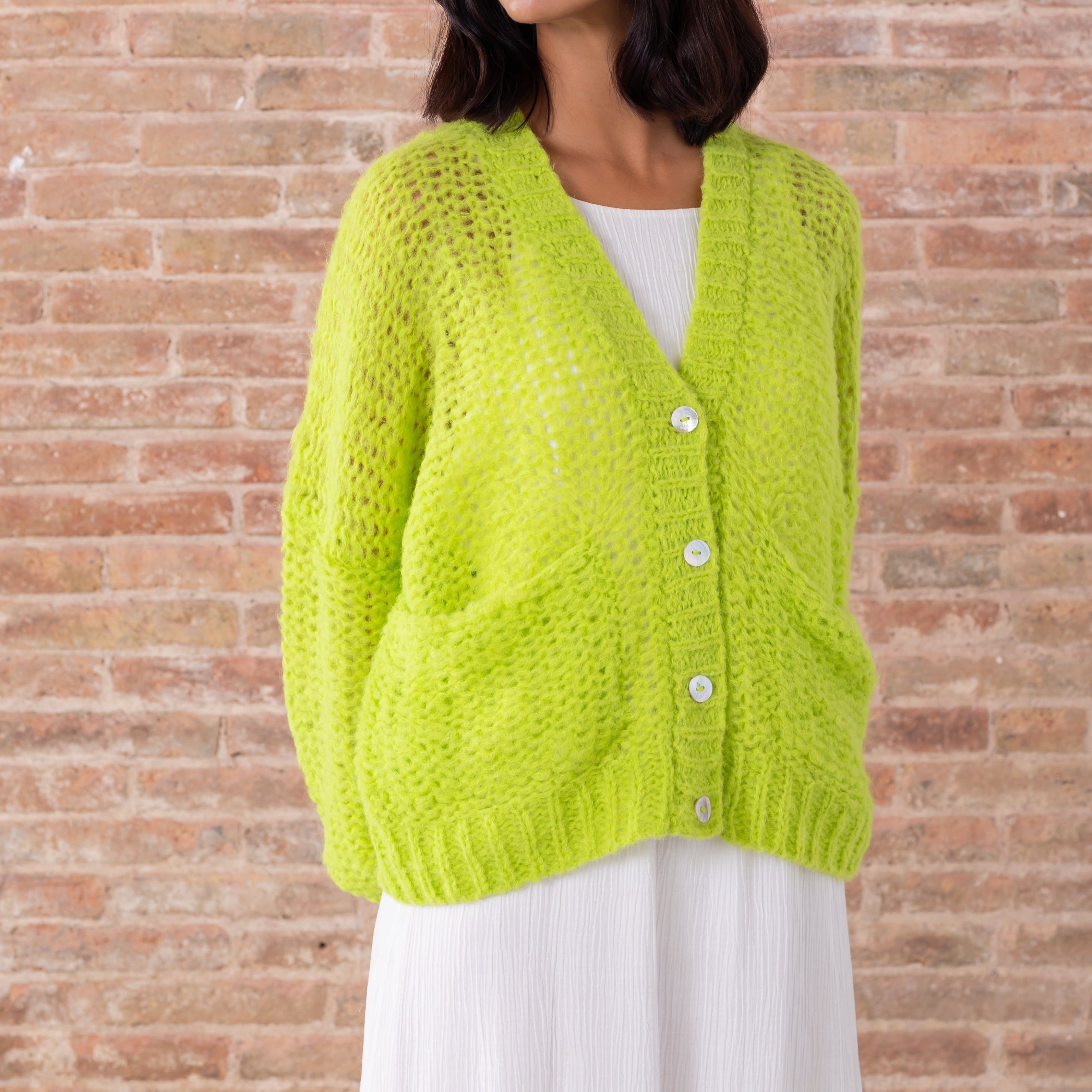 Light green baby alpaca cardigan v neck white buttons modeled front