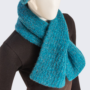 Mannequin wearing a blue knitted scarf on a white background
