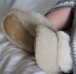 Close-up of fluffy slippers on a soft surface