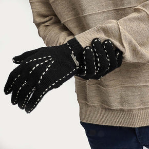 Kuna Willa Alpaca Gloves - model wearing black gloves with white stitching on a neutral background