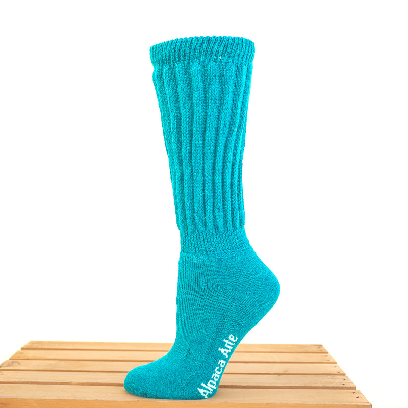 Tey-Art Therapeutic Ribbed Alpaca Socks - A foot on a wooden crate wears Turquoise Tey-Art Therapeutic Ribbed Alpaca Socks against a white background.