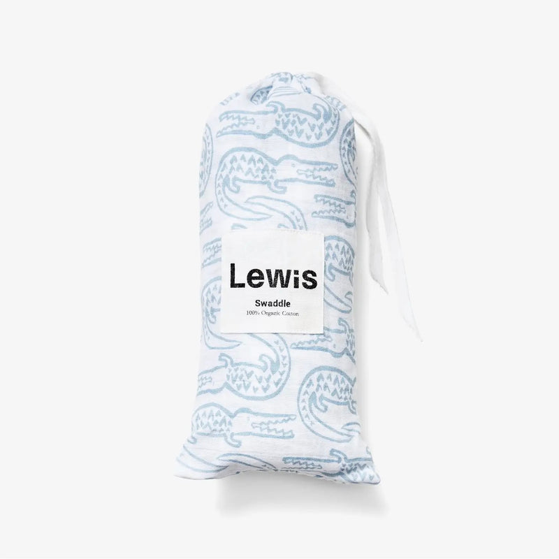 Baby Swaddle - white baby swaddle with blue alligator print in carrying sleeve on a neutral background
