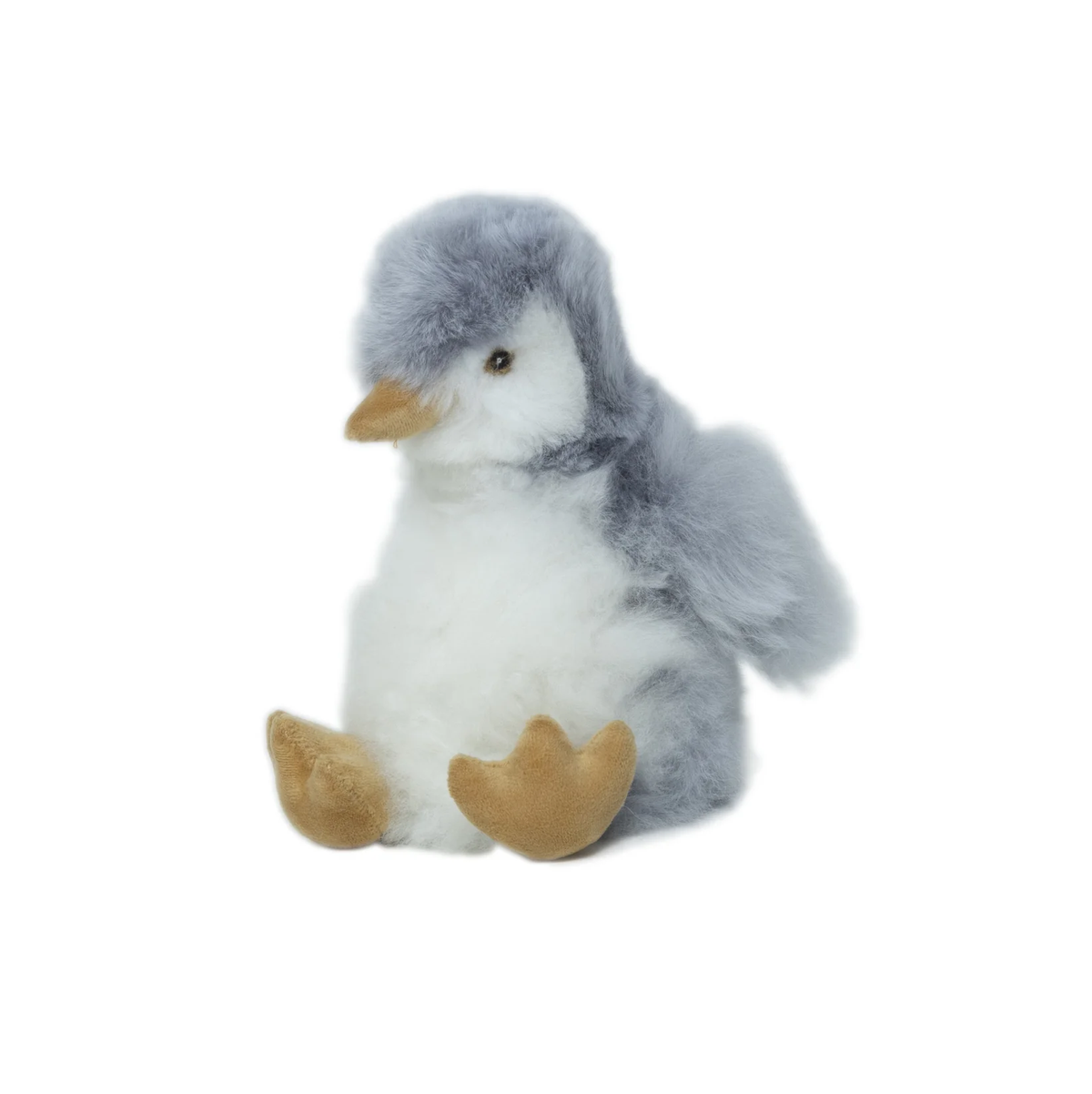 A small plush penguin toy with fluffy gray and white fur, a yellow beak, and tan feet, photographed on a plain white background.