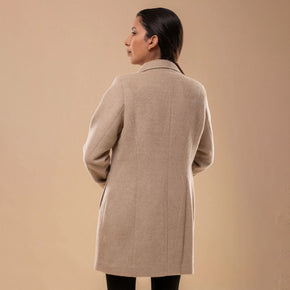 Back view of beige Amelia llama wool coat, highlighting smooth drape and quality wool material.