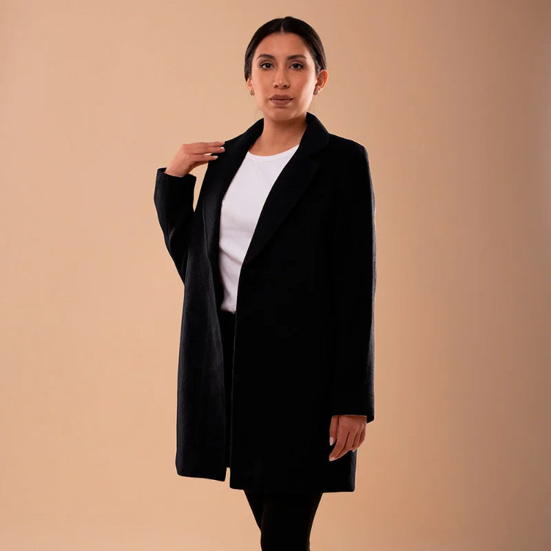 Front view of Amelia llama wool coat in black, showcasing structured design and single button closure.