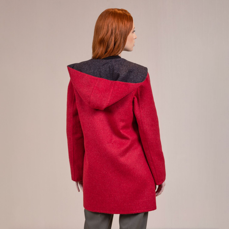 Kuna Anastasia Reversible Coat - model wearing red coat with black lining, toggle buttons, hood, and front pockets