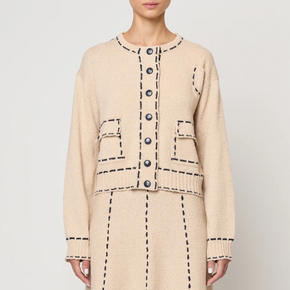 Beige two-piece suit with matching skirt and jacket on a white background