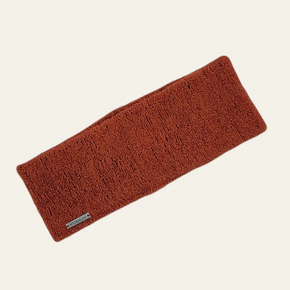Orange knitted headband on a white background