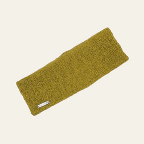 Yellow knitted headband on a beige background