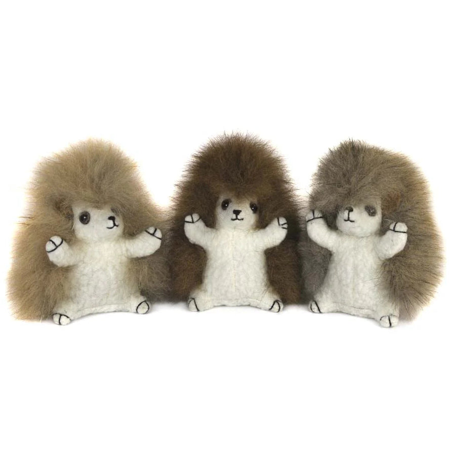 Three plush hedgehogs in a row on a white background