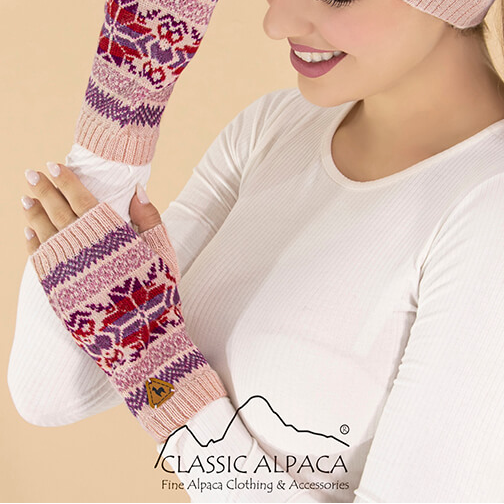 Woman wearing a pink knitted hat and matching arm warmers with a visible brand logo on a beige background.