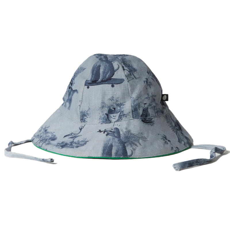 Oeuf Baby Hat – 50% cotton, 50% linen, blue toile patterned hat with ties on a white background