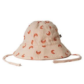 Oeuf Baby Hat – 50% cotton, 50% linen, pink hat with a croissant pattern with ties on a white background