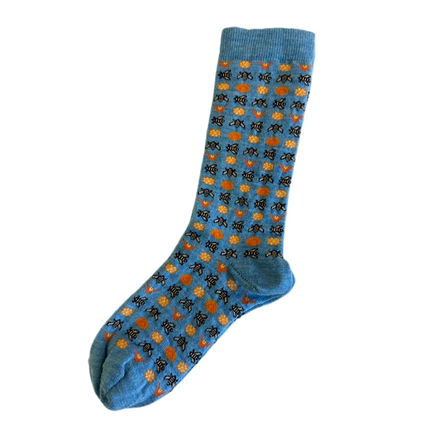 Blue sock with orange and black bee pattern on a white background