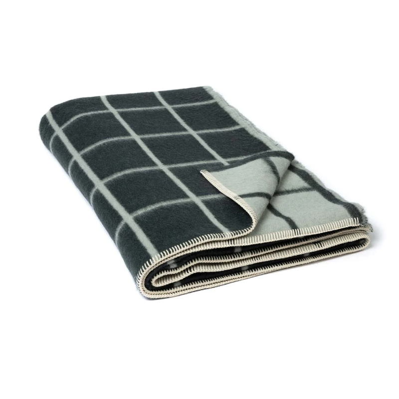 Folded checkered blanket with green and white pattern on a white background